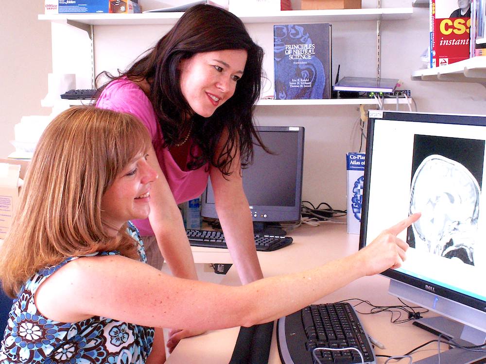 Drs. Pierce and Eyler looking at computer screen