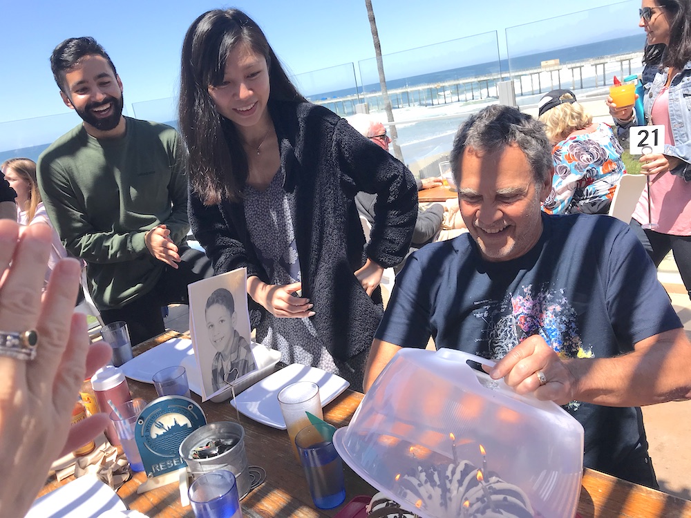 Eric Courchesne and ACE looking at birthday cake