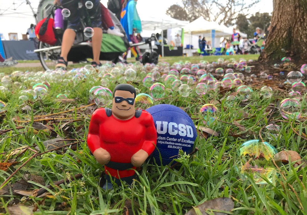 NFAR event in April 2019, image of superhero and UCSD ACE ball