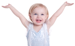 Girl smiling big with both arms up