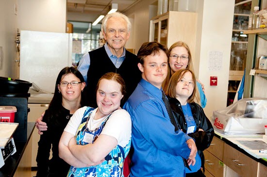 dr. mobley standing with down syndrome patients and other researchers in the lab