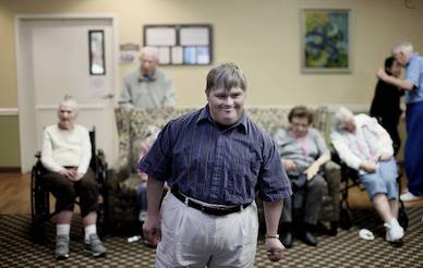 Charles Ahnger, who has Down syndrome and is in the beginning stages of Alzheimer's disease, with other residents at Elmcroft of Point Loma in San Diego on Jan. 10.