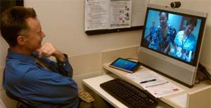 Man on video call with two nurses