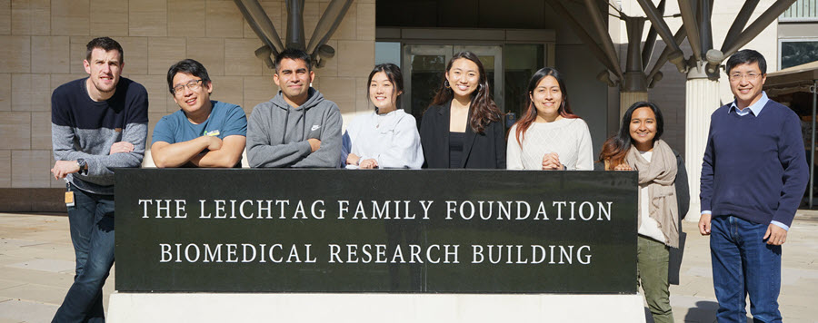 1 of 9, zheng lab members 2019 standing in front of biomedical building 