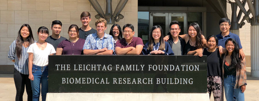 8 of 10, lab members standing in front of biomedical building