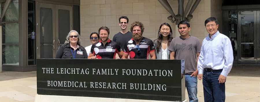 5 of 9, zheng lab members 2019 standing in front of biomedical building